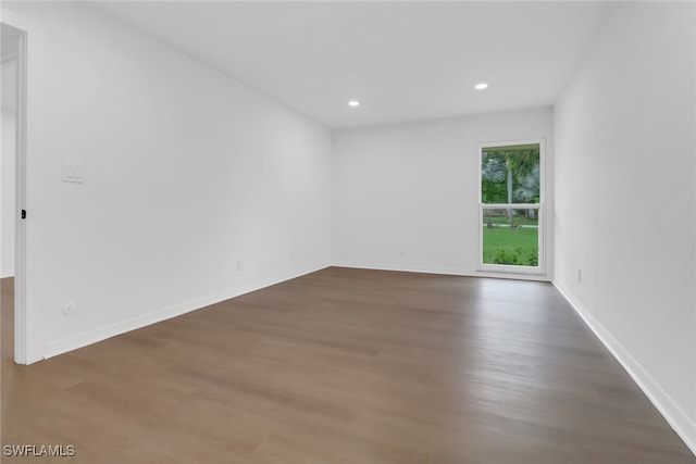 unfurnished room featuring dark wood-type flooring