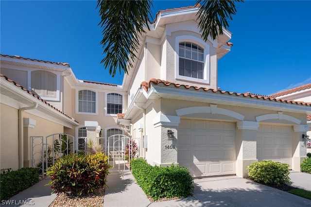 mediterranean / spanish-style home with a garage