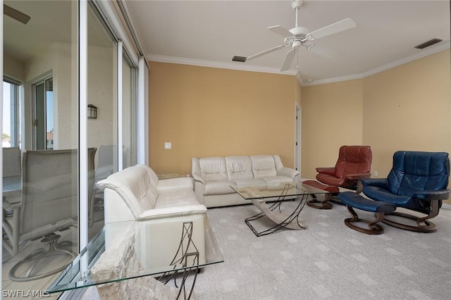 living room with ornamental molding, light colored carpet, and ceiling fan