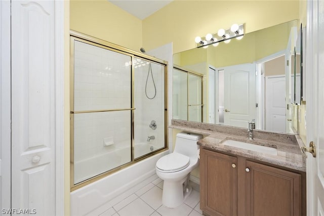 full bathroom featuring toilet, vanity, bath / shower combo with glass door, and tile patterned flooring