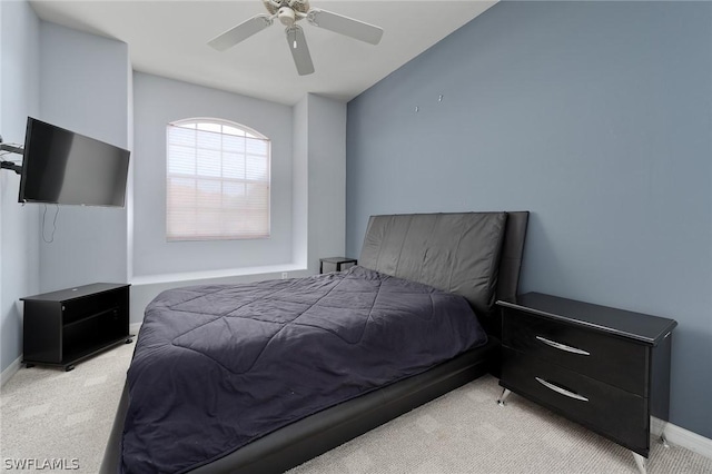 bedroom featuring ceiling fan and light carpet