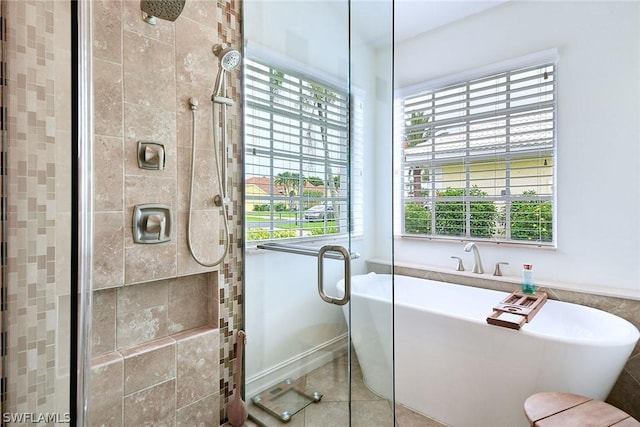 bathroom featuring tile patterned floors and independent shower and bath