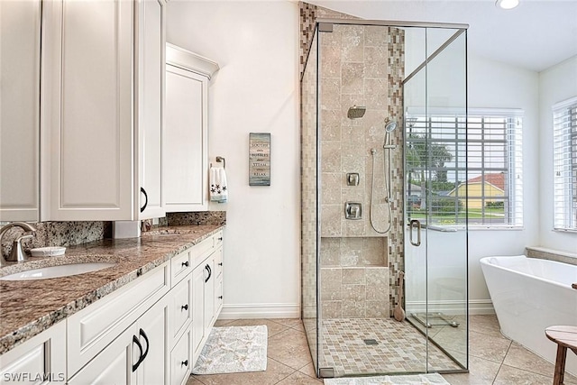 bathroom with tile patterned flooring, vanity, and independent shower and bath