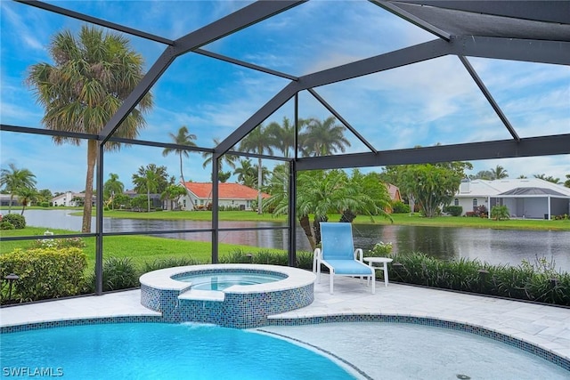 view of pool featuring an in ground hot tub, a water view, glass enclosure, and a patio