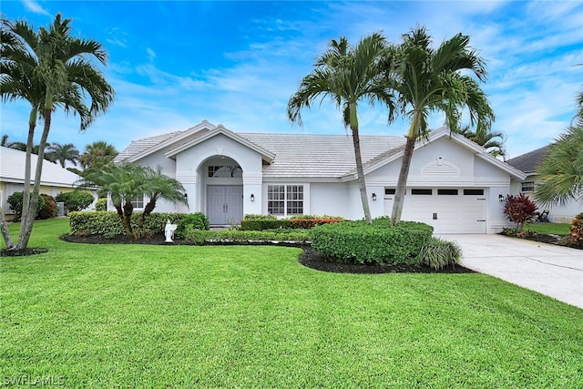 ranch-style house with a garage and a front yard