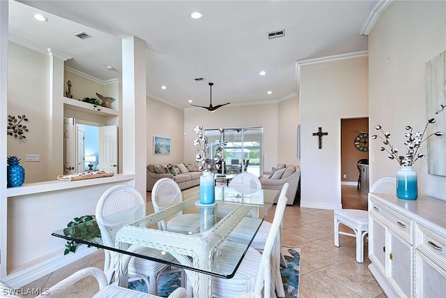 dining area featuring light tile patterned flooring and ornamental molding