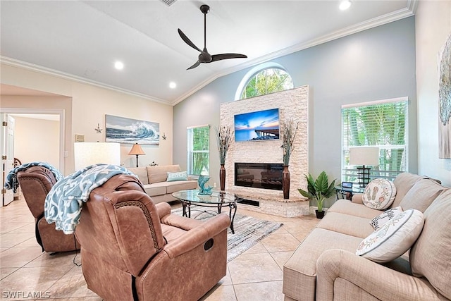 living room featuring light tile patterned flooring, a fireplace, lofted ceiling, ornamental molding, and ceiling fan