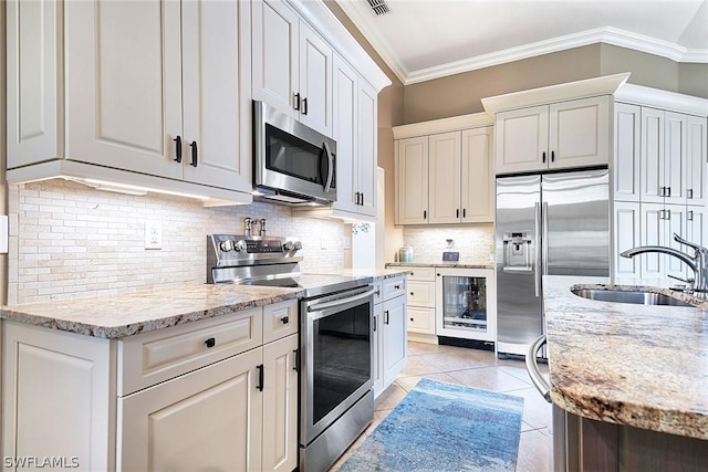 kitchen with sink, stainless steel appliances, and white cabinets