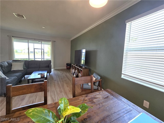 living room featuring crown molding and wood-type flooring