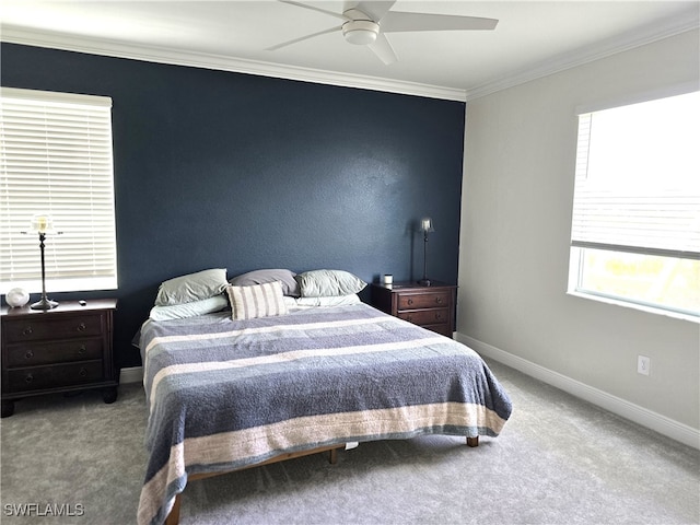 carpeted bedroom with ceiling fan and ornamental molding