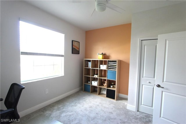 office space with light carpet and ceiling fan