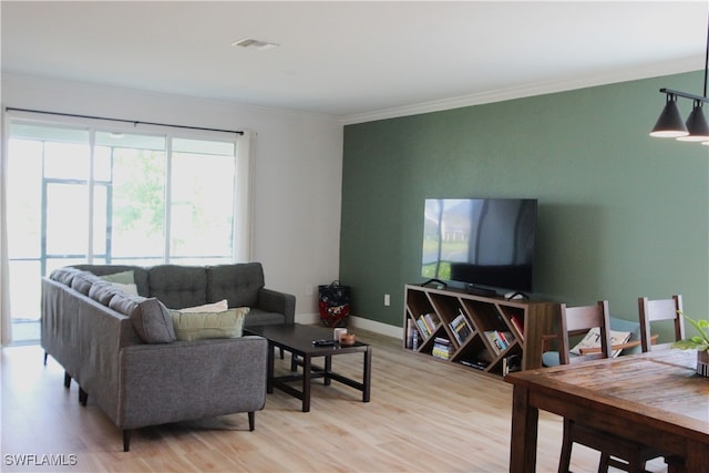 living room featuring light hardwood / wood-style flooring and ornamental molding