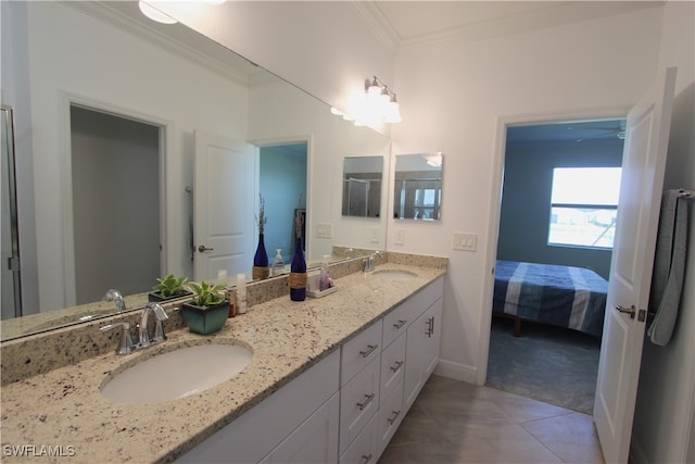 bathroom featuring ornamental molding, dual bowl vanity, and tile patterned floors