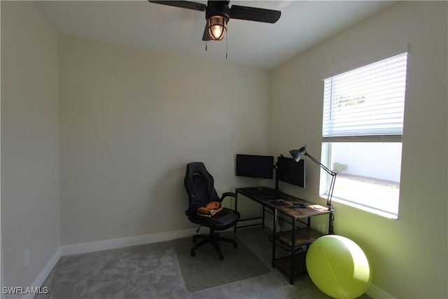 carpeted office space with ceiling fan