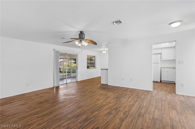 unfurnished living room with ceiling fan and dark hardwood / wood-style flooring