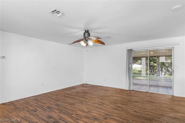 empty room featuring ceiling fan and dark hardwood / wood-style floors