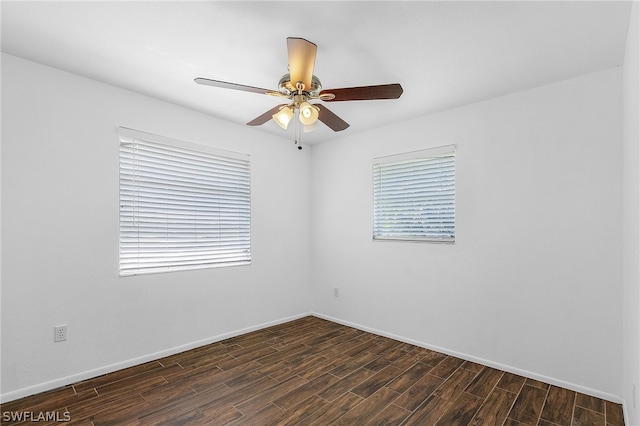 empty room featuring ceiling fan and dark hardwood / wood-style flooring