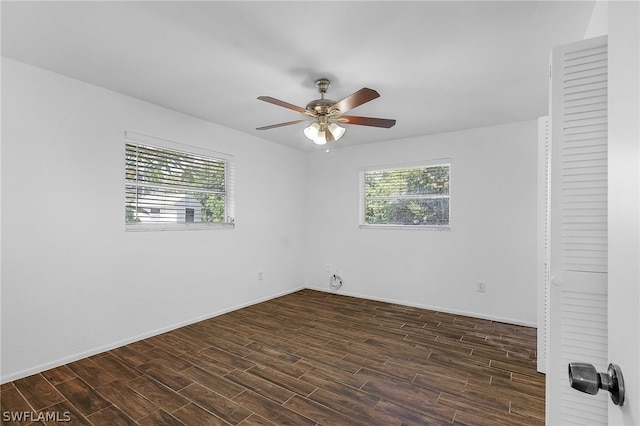 unfurnished room with a wealth of natural light, dark hardwood / wood-style flooring, and ceiling fan