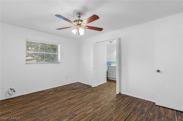 empty room featuring ceiling fan and dark hardwood / wood-style flooring