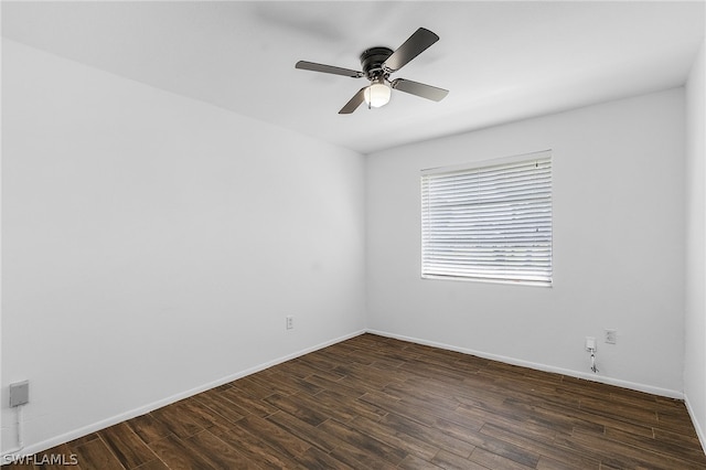 empty room featuring ceiling fan and dark wood-type flooring