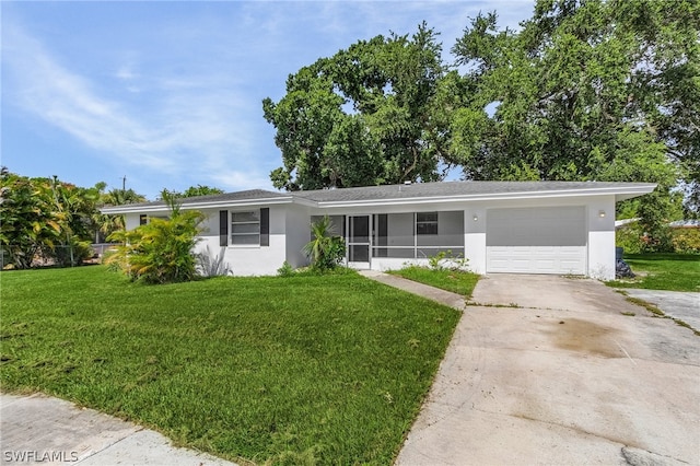 ranch-style home featuring a front lawn and a garage