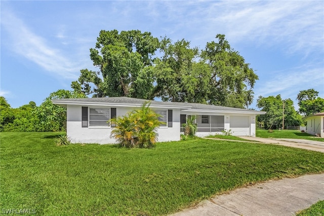 ranch-style house featuring a garage and a front lawn