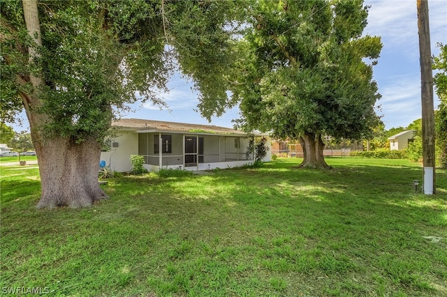 view of yard with a sunroom