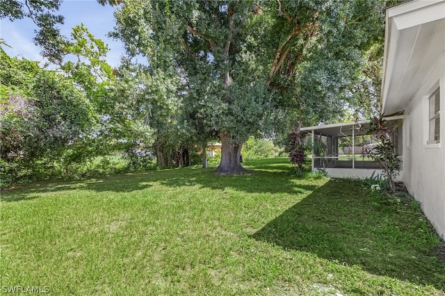 view of yard featuring a sunroom