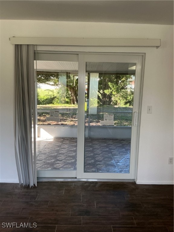 doorway to outside with plenty of natural light and dark hardwood / wood-style floors