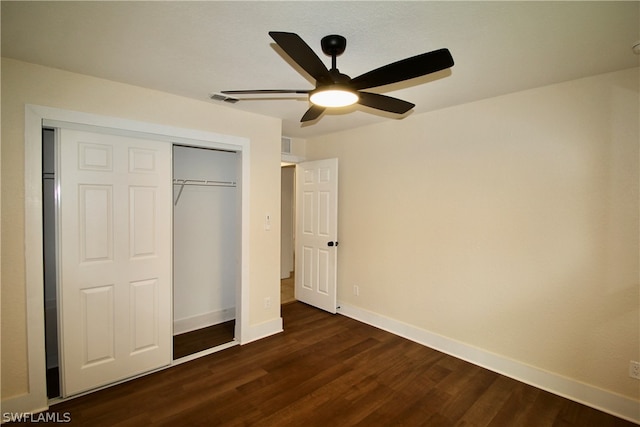 unfurnished bedroom featuring ceiling fan, dark hardwood / wood-style flooring, and a closet