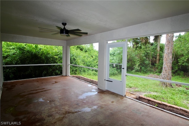 unfurnished sunroom with ceiling fan