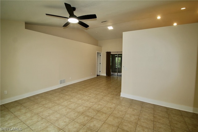 tiled empty room featuring ceiling fan and vaulted ceiling