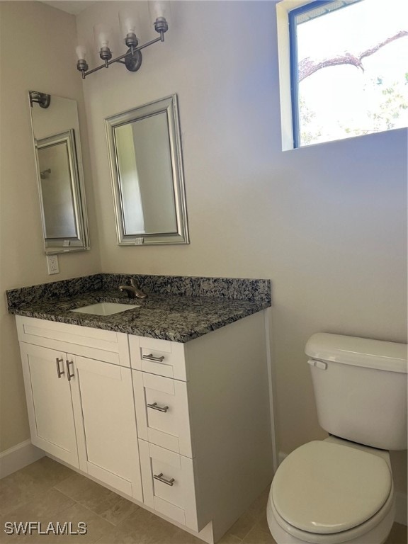 bathroom with tile patterned floors, toilet, and vanity