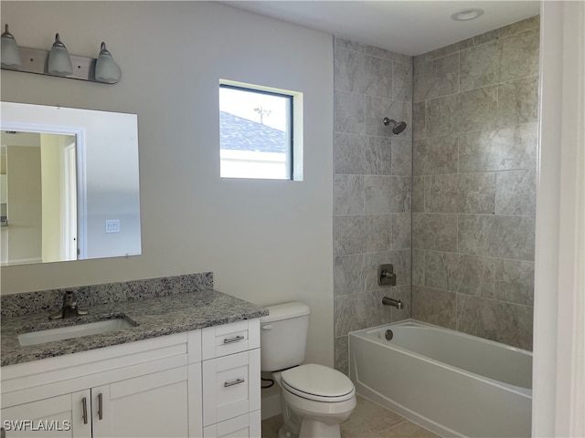 full bathroom with tile patterned floors, tiled shower / bath, toilet, and vanity