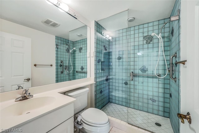 bathroom featuring an enclosed shower, vanity, and toilet