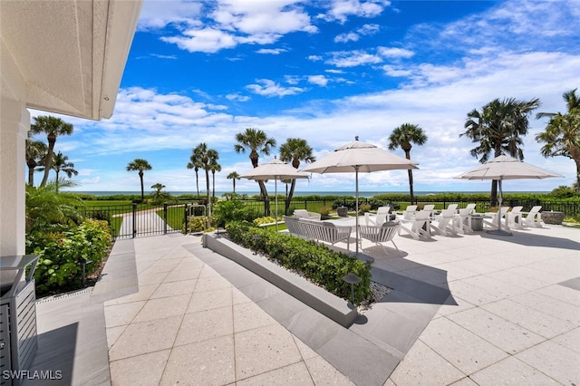 surrounding community featuring fence and a patio