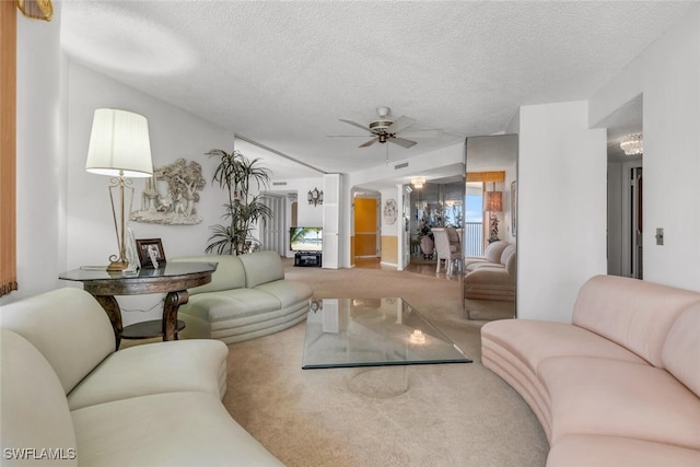 living area featuring a textured ceiling, visible vents, carpet, and a ceiling fan