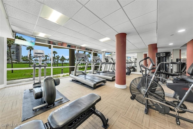 gym with a paneled ceiling