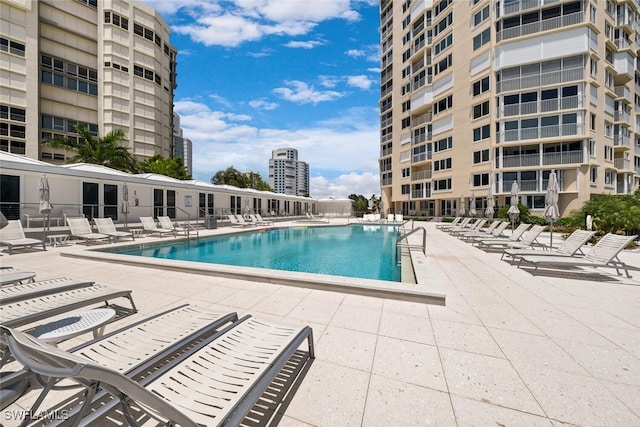 community pool featuring a patio area and a city view