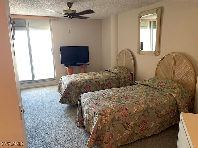 carpeted bedroom with a ceiling fan and a textured ceiling