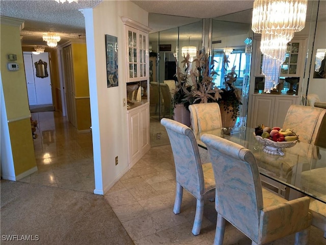 dining room with a textured ceiling, light colored carpet, and an inviting chandelier