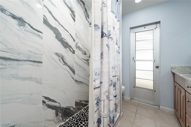 bathroom with tile patterned floors, vanity, curtained shower, and toilet