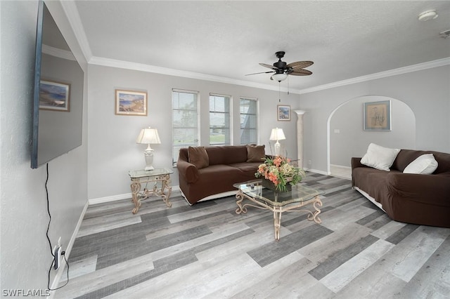 living room featuring ceiling fan, light wood-type flooring, and ornamental molding