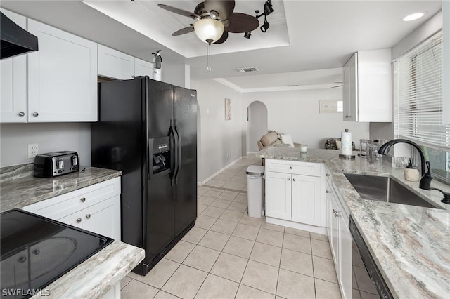 kitchen featuring white cabinetry, sink, a raised ceiling, black fridge with ice dispenser, and exhaust hood