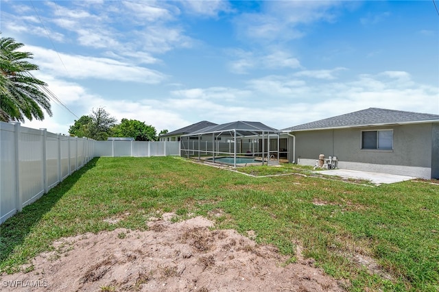 view of yard with a lanai, a fenced in pool, and a patio