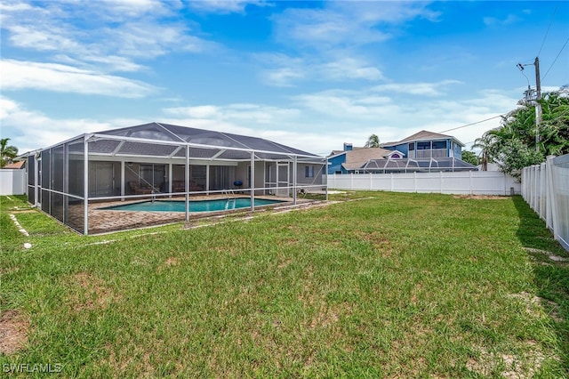 view of yard with a fenced in pool and glass enclosure