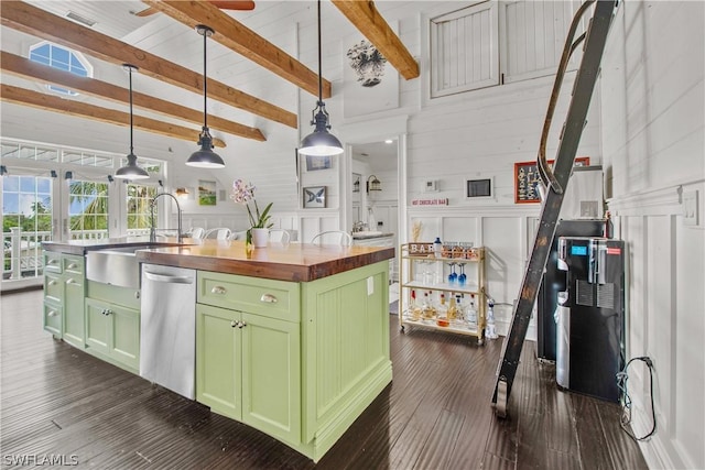 kitchen with an island with sink, green cabinets, decorative light fixtures, dishwasher, and wooden counters