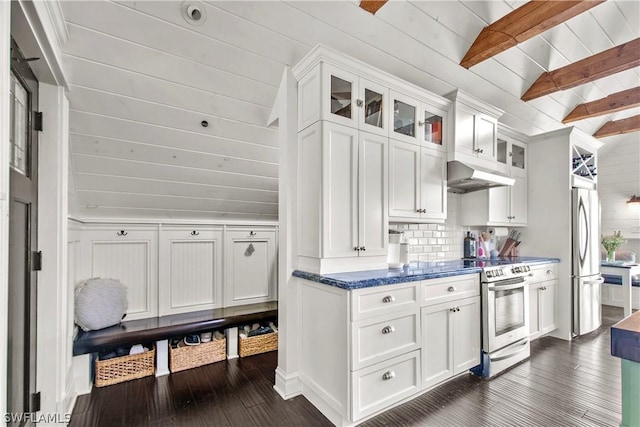 kitchen with white cabinetry, stainless steel appliances, and lofted ceiling with beams