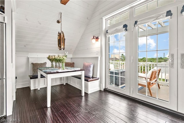 home office with vaulted ceiling, hardwood / wood-style floors, and breakfast area