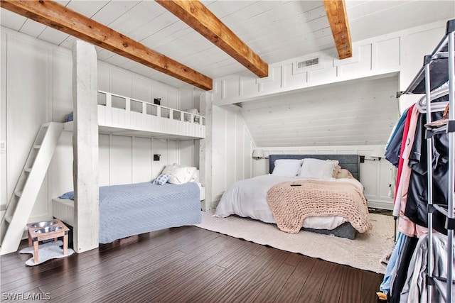 bedroom with beam ceiling and dark wood-type flooring